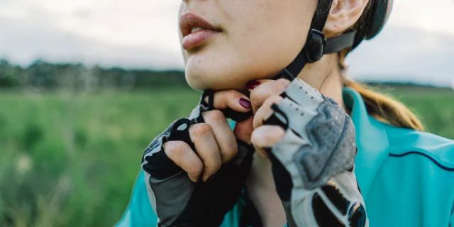 Cyclist fastening his helmet