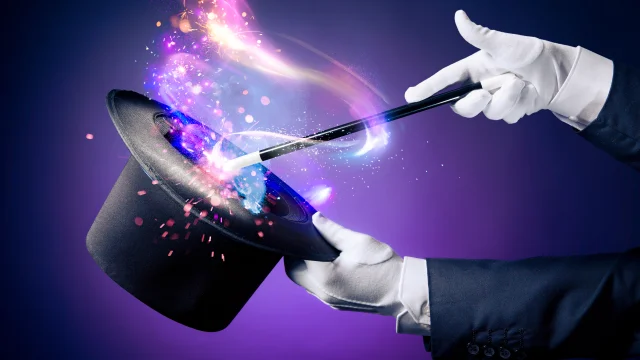 Magician hand with magic wand and hat