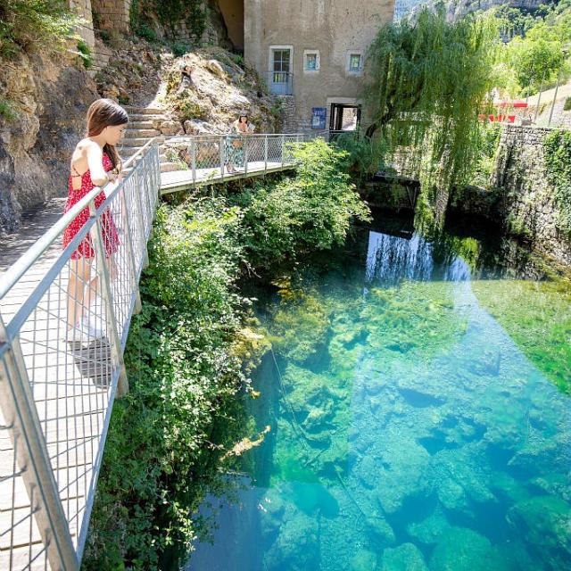 A family discovers the Burle spring in the village of Sainte-Enimie, in the heart of the Gorges du Tarn