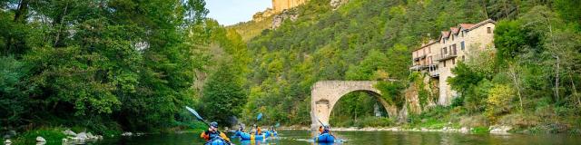 A packraft group on the broken Rozier bridge at sunset