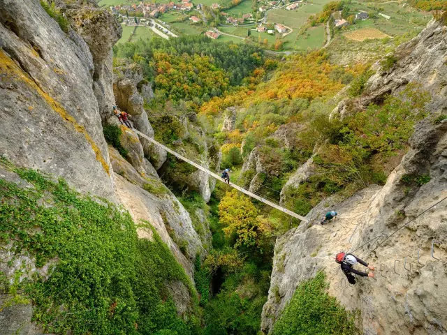 A group accompanied by a guide crosses a footbridge on the Liaucous Via Ferrata.