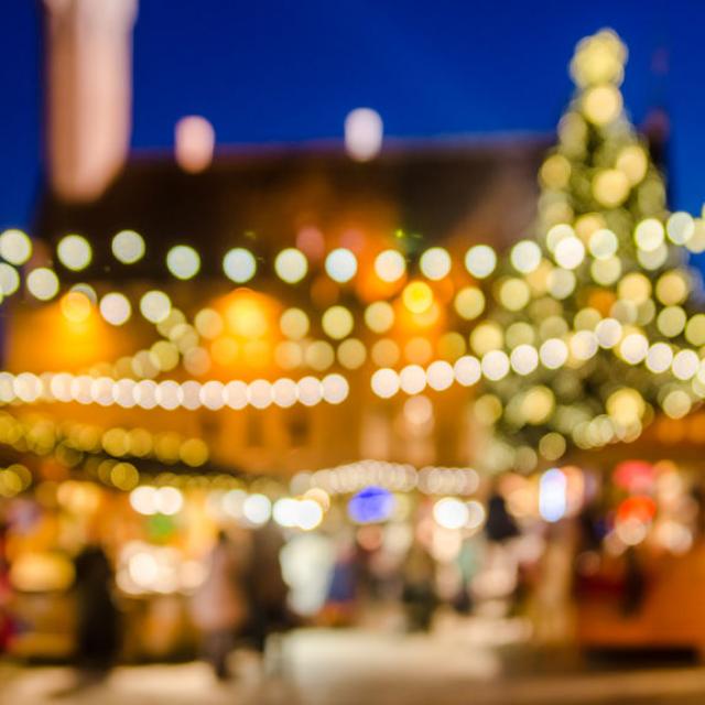 56075127 - decorated christmas market. abstract blurred lights background