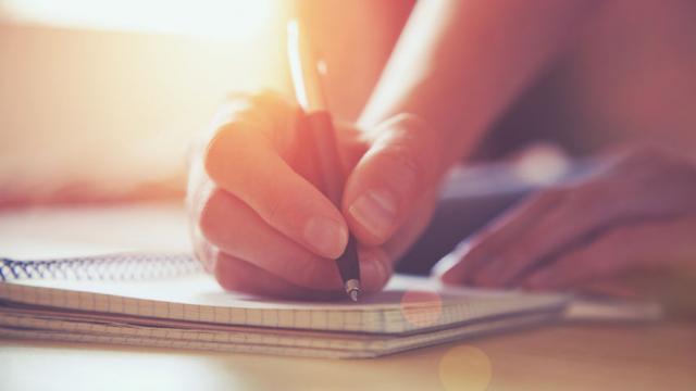 46651061 - female hands with pen writing on notebook