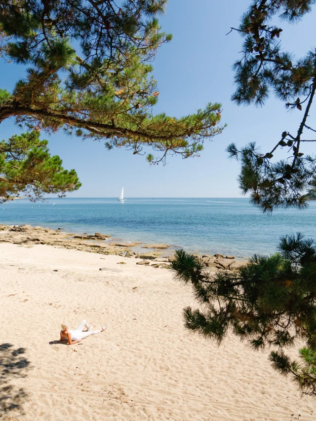 Woman sunbathing on Plage du Coq