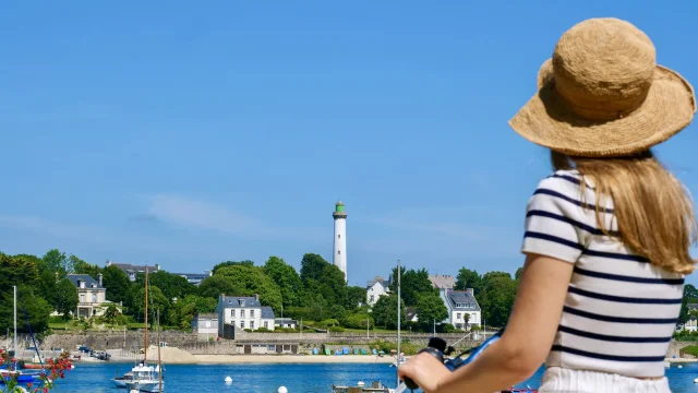 Young woman on bicycle admiring Bénodet from Sainte-Marine