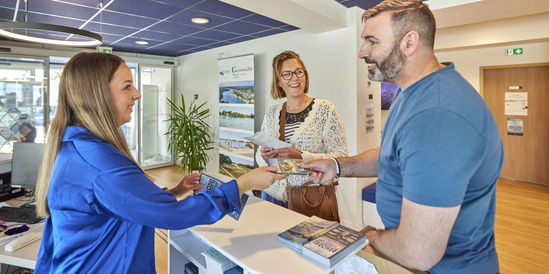 Conseillère en séjour renseignant des visiteurs à l'Office de Tourisme de Bénodet