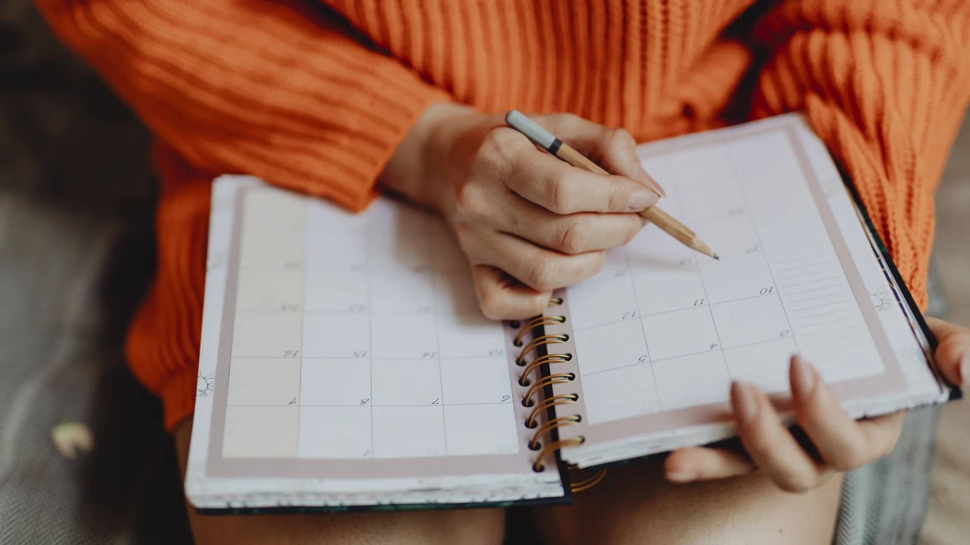 Woman writing on her daily planner
