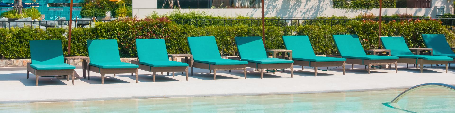 Umbrella And Chair Around Swimming Pool