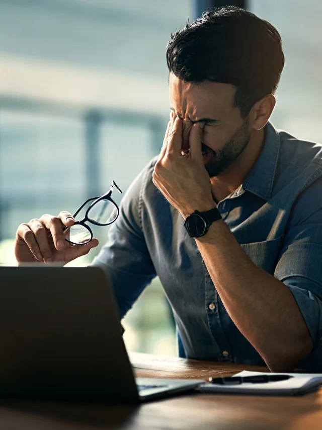 Struggling with occupational stress. Shot of a young businessman experiencing stress during a late night at work