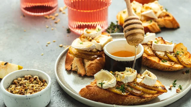 toasts croutons with cheese camembert and pear, honey, walnut, banner, menu, recipe place for text, top view,