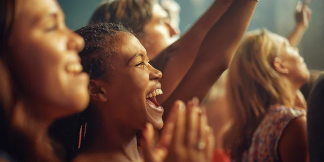 Young girls in an audience enjoying their favourite bands performance