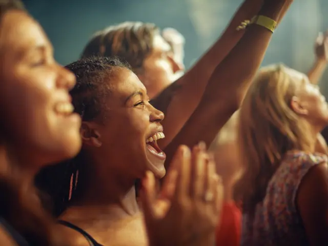 Young girls in an audience enjoying their favourite bands performance