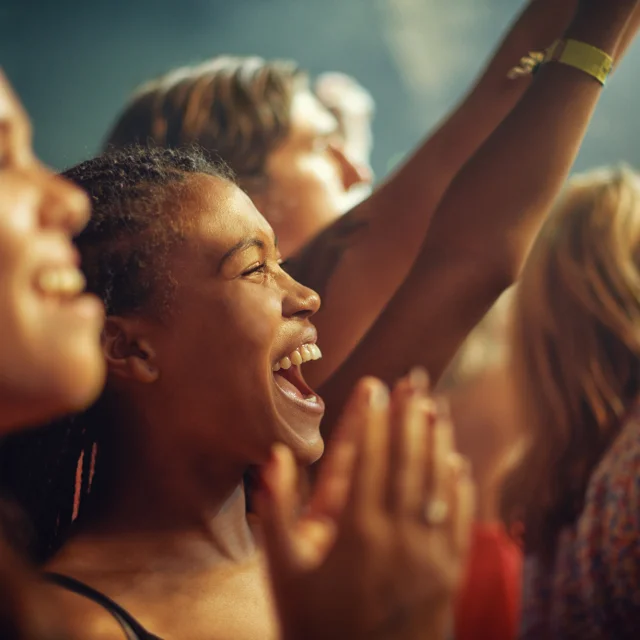 Young girls in an audience enjoying their favourite bands performance