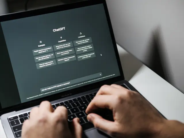 Screen with ChatGPT chat with AI or artificial intelligence. Man search for information using artificial intelligence chatbot developed by OpenAI. Warsaw, Poland - December 02, 2022.