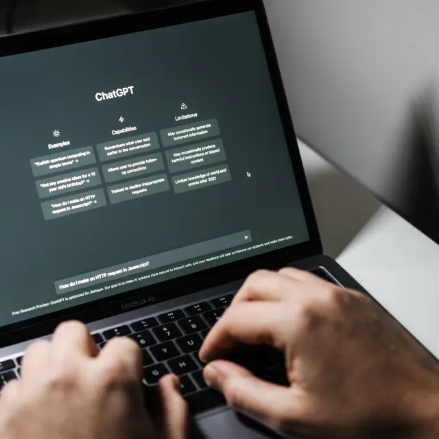 Screen with ChatGPT chat with AI or artificial intelligence. Man search for information using artificial intelligence chatbot developed by OpenAI. Warsaw, Poland - December 02, 2022.