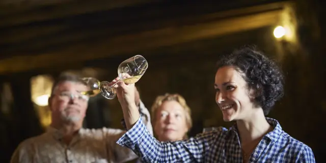 photo of wine tasting in a cellar in the val de loire, muscadet du pays nantais, chateau du Coing. glass of muscadet
