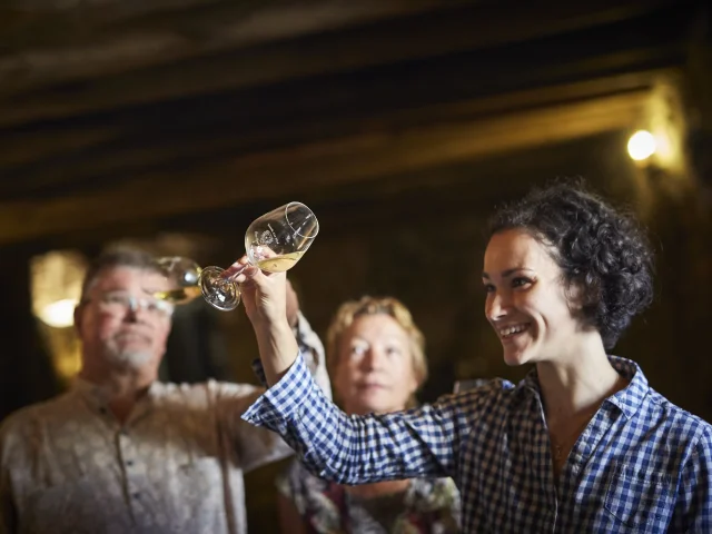 photo of wine tasting in a cellar in the val de loire, muscadet du pays nantais, chateau du Coing. glass of muscadet