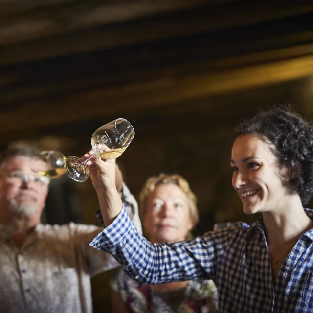 photo of wine tasting in a cellar in the val de loire, muscadet du pays nantais, chateau du Coing. glass of muscadet