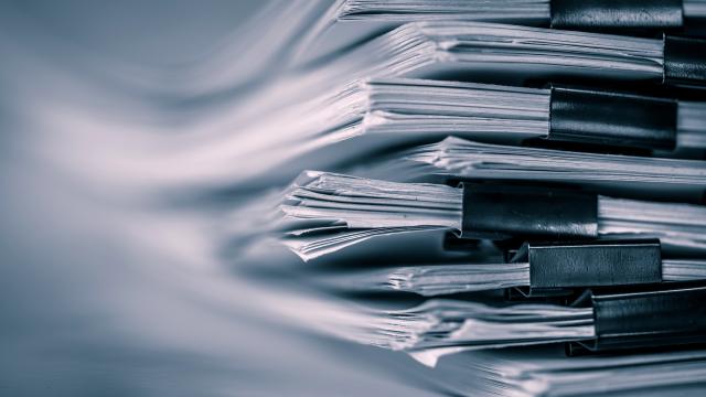 extreamely close up  report paper stacking of office working document , retro color tone