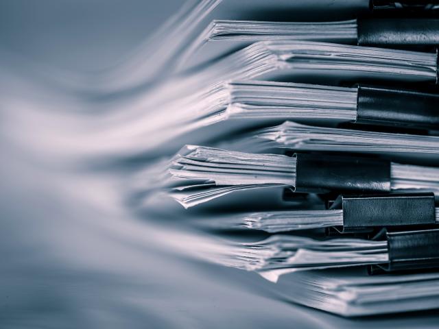 extreamely close up  report paper stacking of office working document , retro color tone