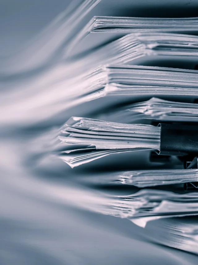 extreamely close up report paper stacking of office working document , retro color tone