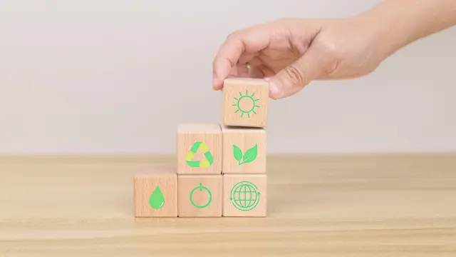 Hand arranging wood block. Recycle symbol Green sun, leaves, water drops, globe, on-off switch on the wooden cube. World environment and earth day. save world concept. taking care nature and ecology.