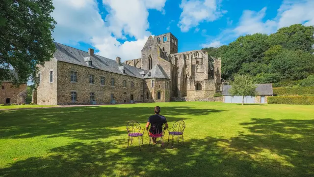 Two children playing a bowling game in front of a stone castle