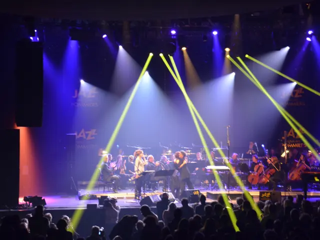 A band performing on stage with colorful spotlights