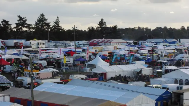 Crowd of people at a festival with tents and stalls