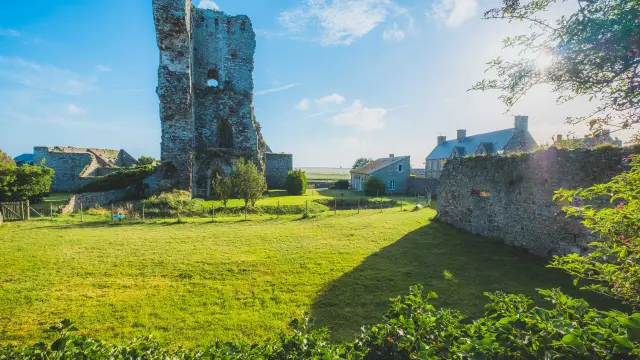 Medieval stone tower and ancient ruins illuminated by evening light