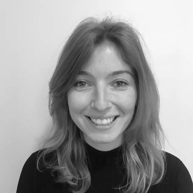 Portrait en noir et blanc d'une femme souriante avec des cheveux longs