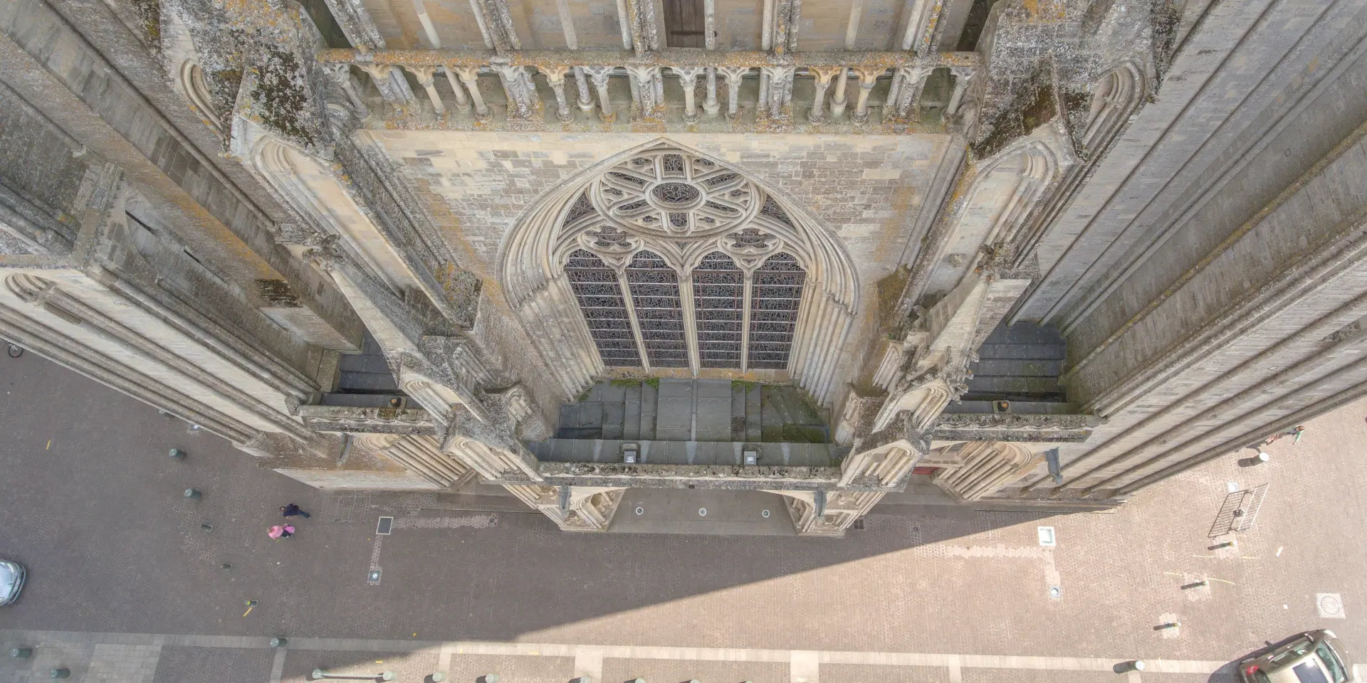 Aerial view of the facade of a Gothic cathedral with a large rose window