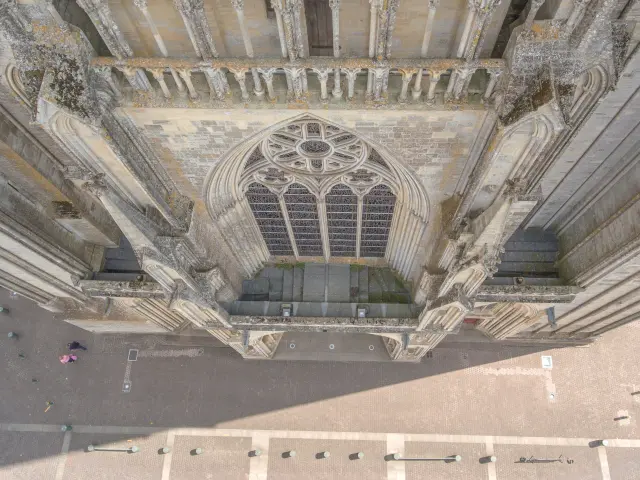 Aerial view of the facade of a Gothic cathedral with a large rose window