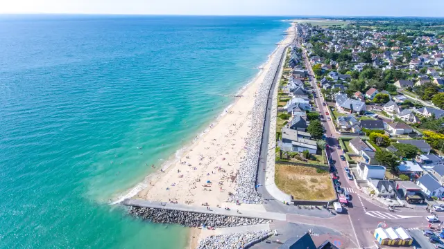 Aerial view of a fine sandy beach bordered by coastal houses