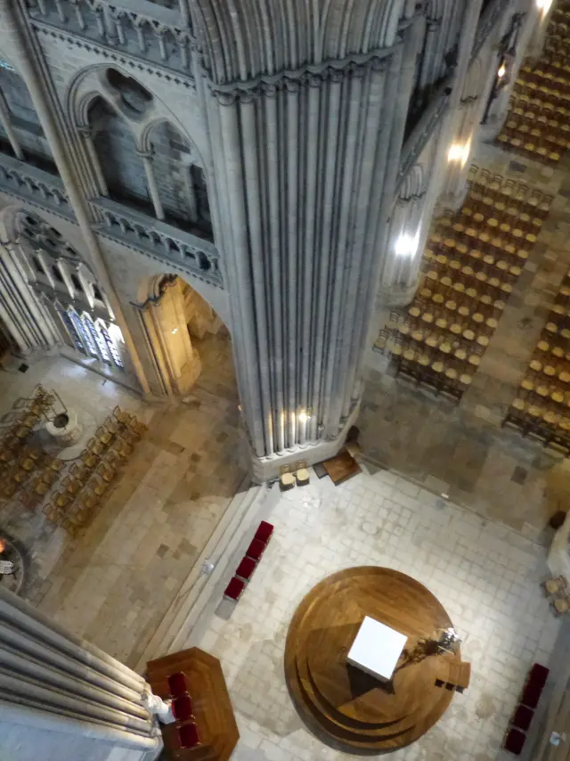 Aerial view of the interior of a cathedral with columns and pews