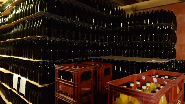 Shelves filled with bottles of wine and crates of bottles
