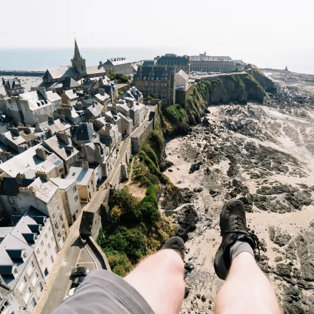 Aerial view of a village perched on a cliff near the sea