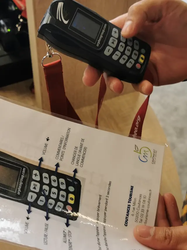 A person holding a mobile phone and a user manual