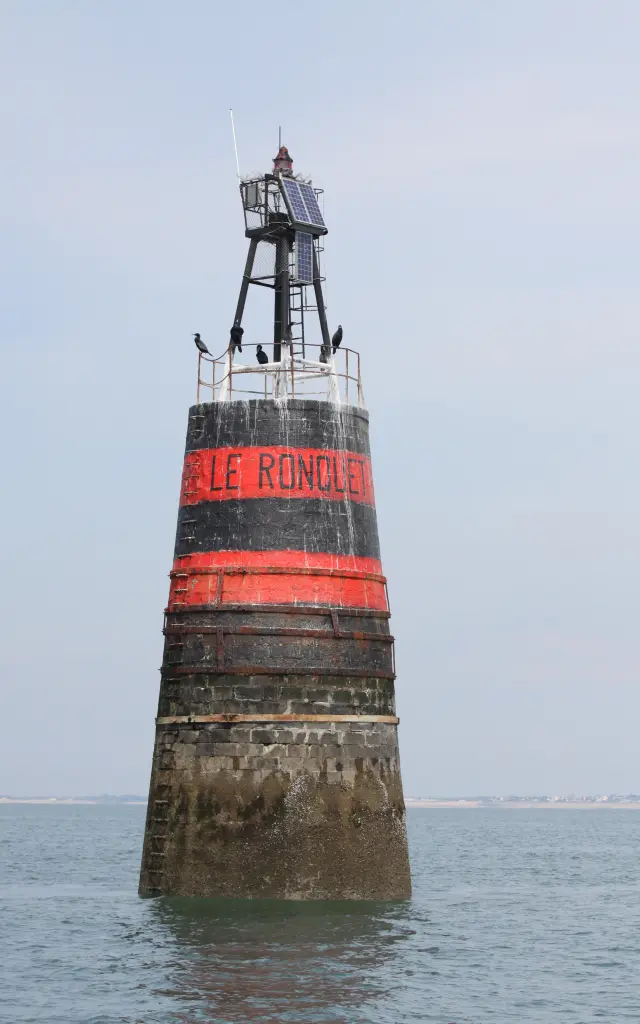Le Rondel Lighthouse with a metal structure and a red band