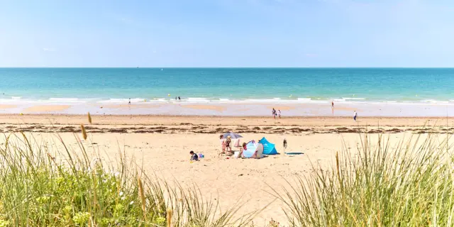 Famille en vacances sur une plage de sable fin