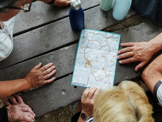 Group of people studying a map for a hike