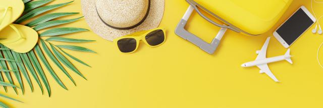 Flat lay yellow suitcase with traveler accessories and tropical palm leaves on yellow background. travel concept. 3d rendering