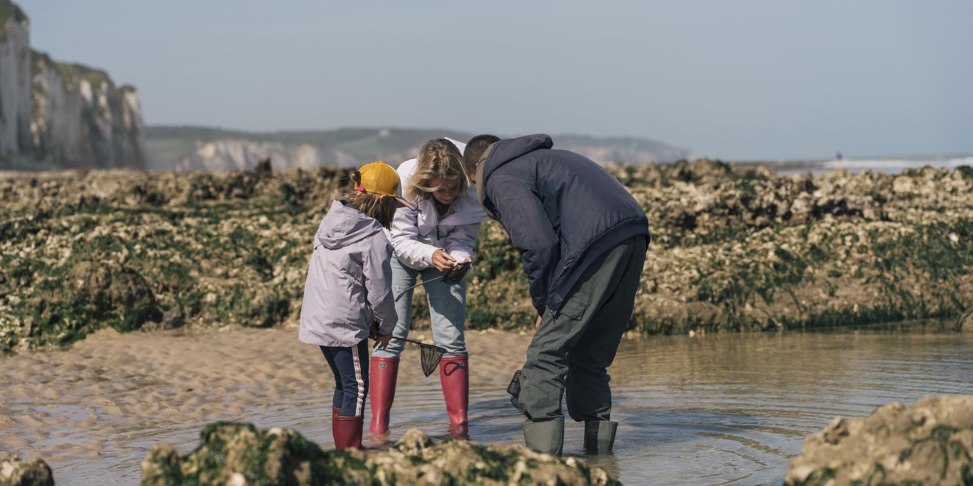 Une maman et sa famille, en compagnie d'un guide observent des animaux qu'ils viennent de pêcher