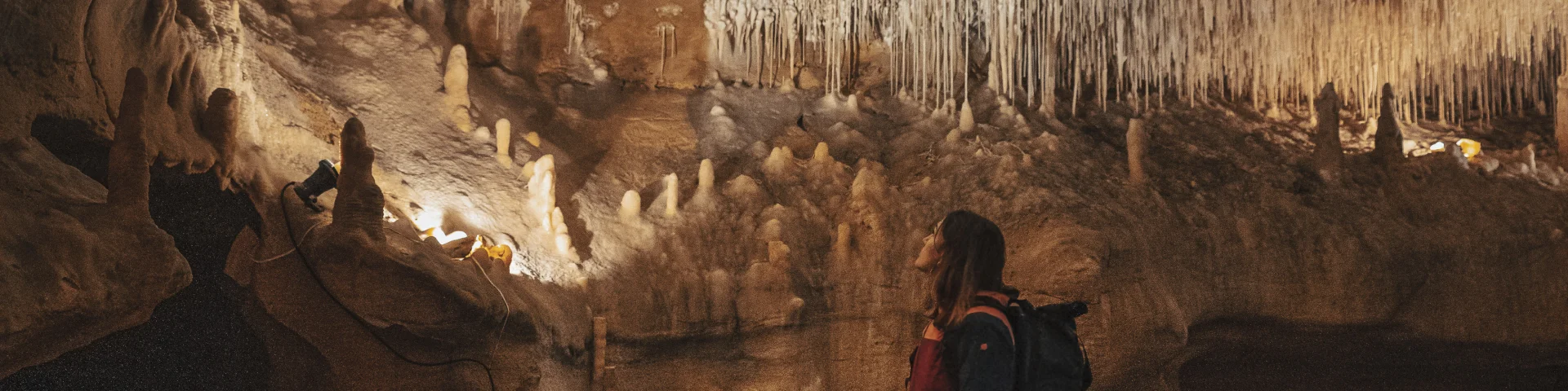 Woman under the concretions in the Cougnac caves