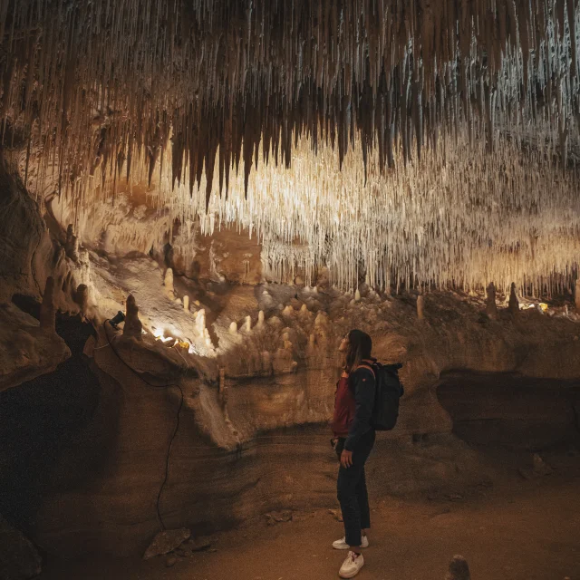 Woman under the concretions in the Cougnac caves