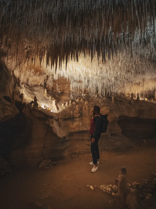 Woman under the concretions in the Cougnac caves