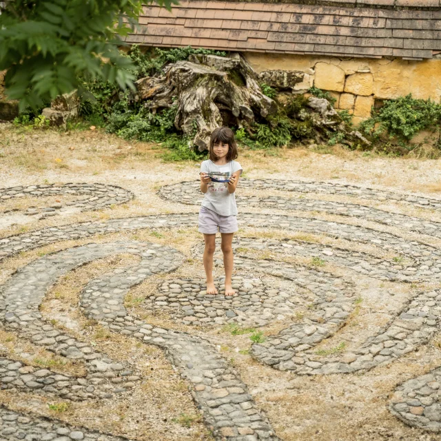 Barefoot child on a stone maze