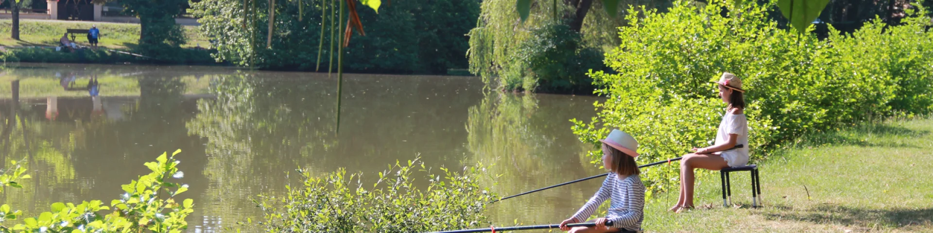 Two little girls in a nature fishing workshop