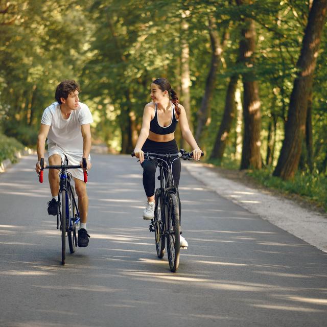 Velo Sports Couple Riding Bikes In Summer Forest