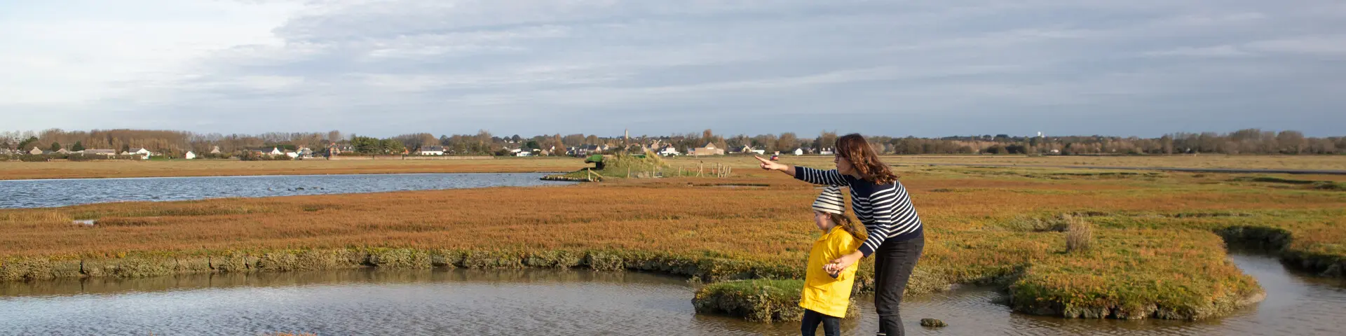Une mère et sa fille se promènent dans les prés salés du havre de la Vanlée à Bricqueville-sur-Mer